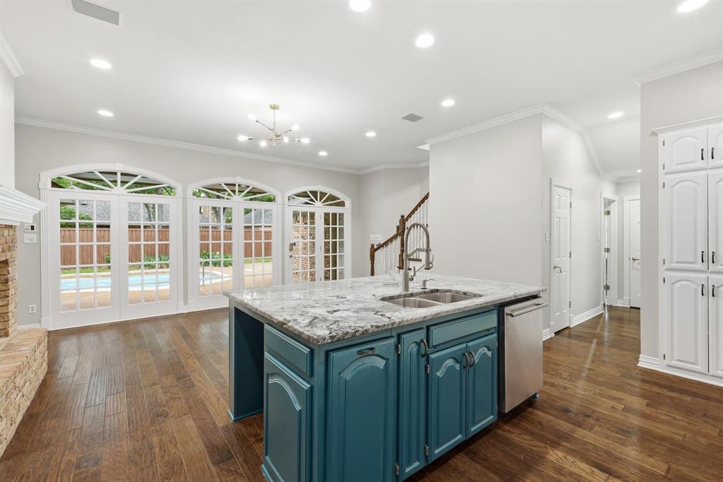 848 Birdsong Bedford, TX 76021 - Photo 8 of 40 a kitchen with stainless steel appliances granite countertop a kitchen island a stove and a wooden floors