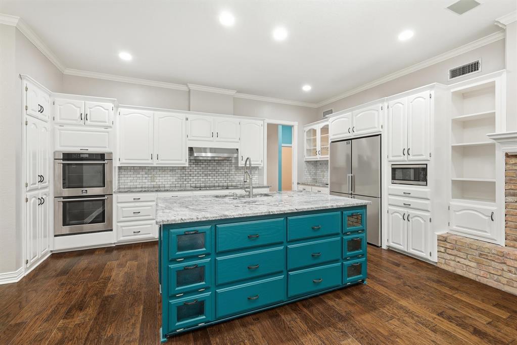 848 Birdsong Bedford, TX 76021 - Photo 9 of 40 a kitchen with stainless steel appliances granite countertop a refrigerator and a stove top oven