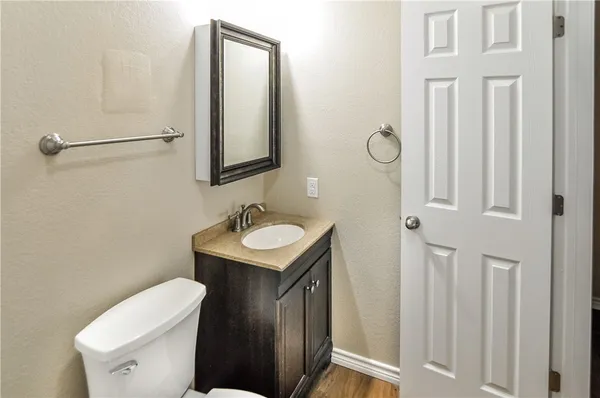 a bathroom with a sink a toilet and mirror