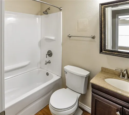 a white toilet sitting next to a bath tub