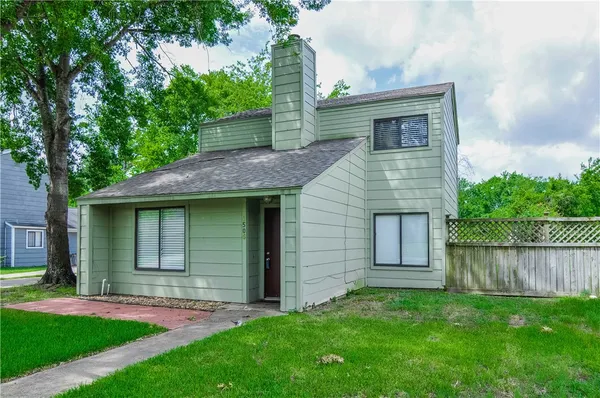 a front view of a house with a garden and yard