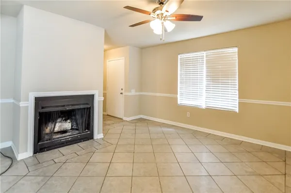 a view of an empty room with a fireplace and a window