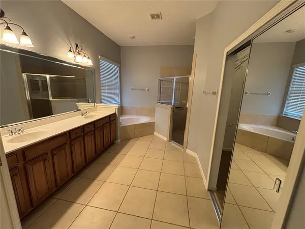 a bathroom with a double vanity sink and mirror