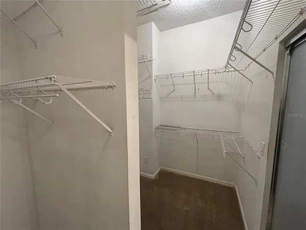 an empty room with windows and entrance