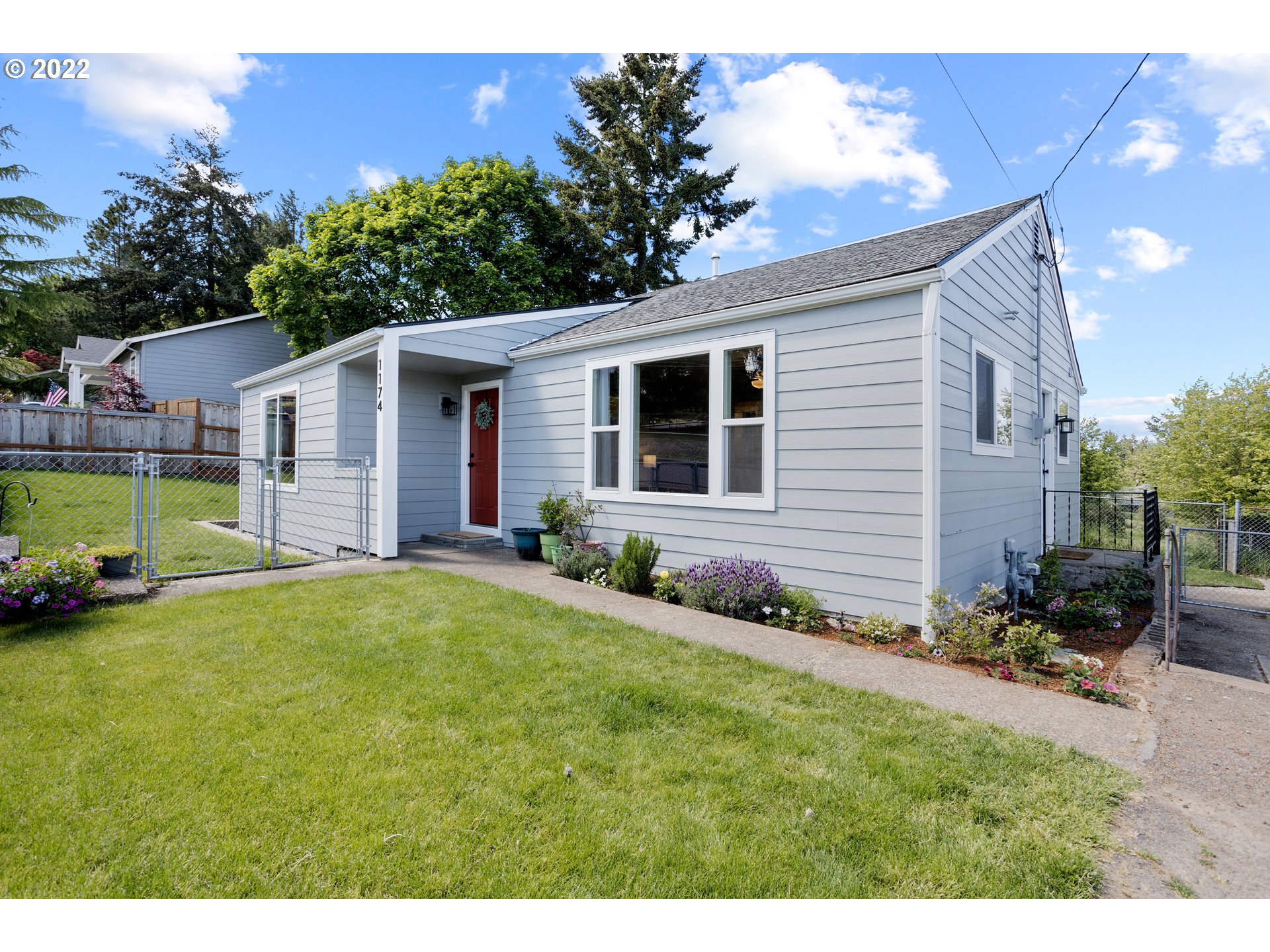 1174 Southwest Maple Street Dallas, OR 97338 - Photo 1 of 32 a view of a house with a yard and potted plants