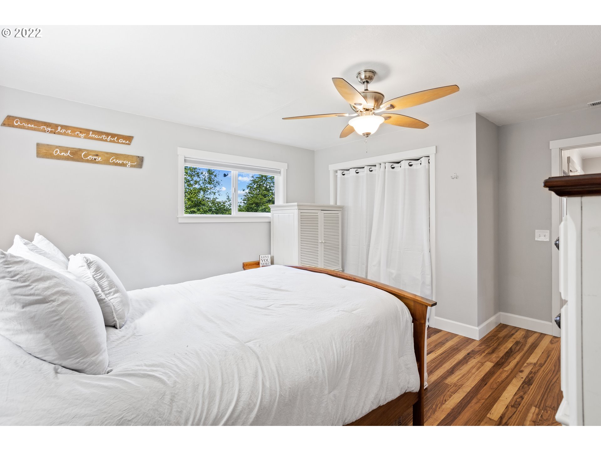1174 Southwest Maple Street Dallas, OR 97338 - Photo 14 of 32 a bedroom with a bed and a chandelier