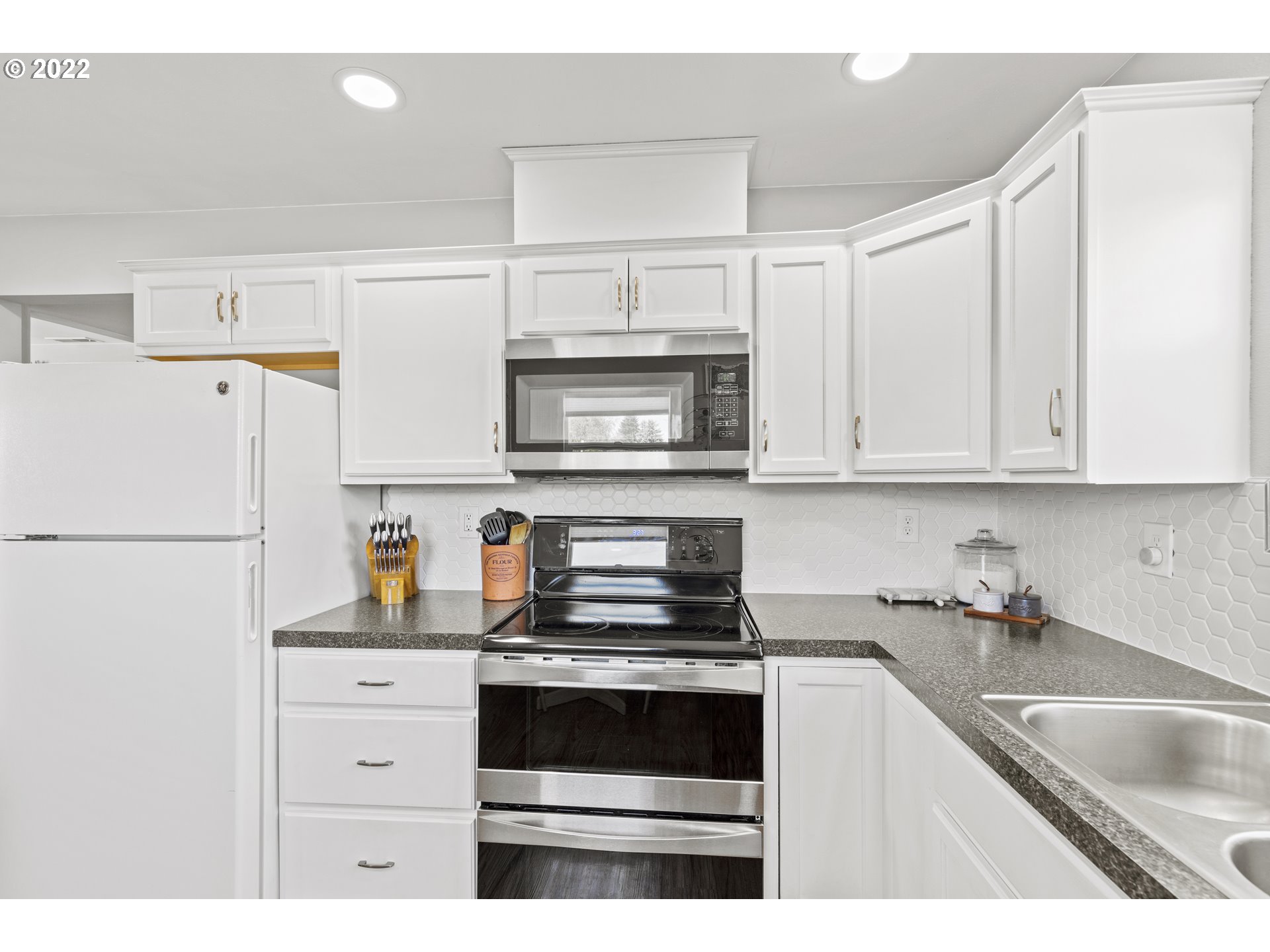 1174 Southwest Maple Street Dallas, OR 97338 - Photo 10 of 32 a kitchen with granite countertop white cabinets and white appliances