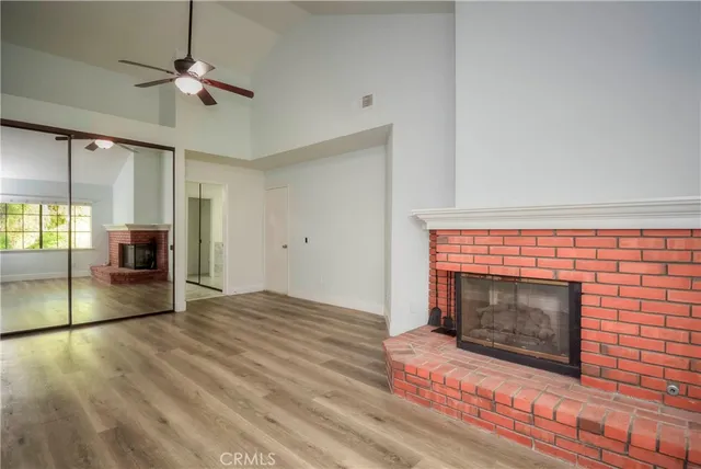 a living room with a fireplace with wooden floor