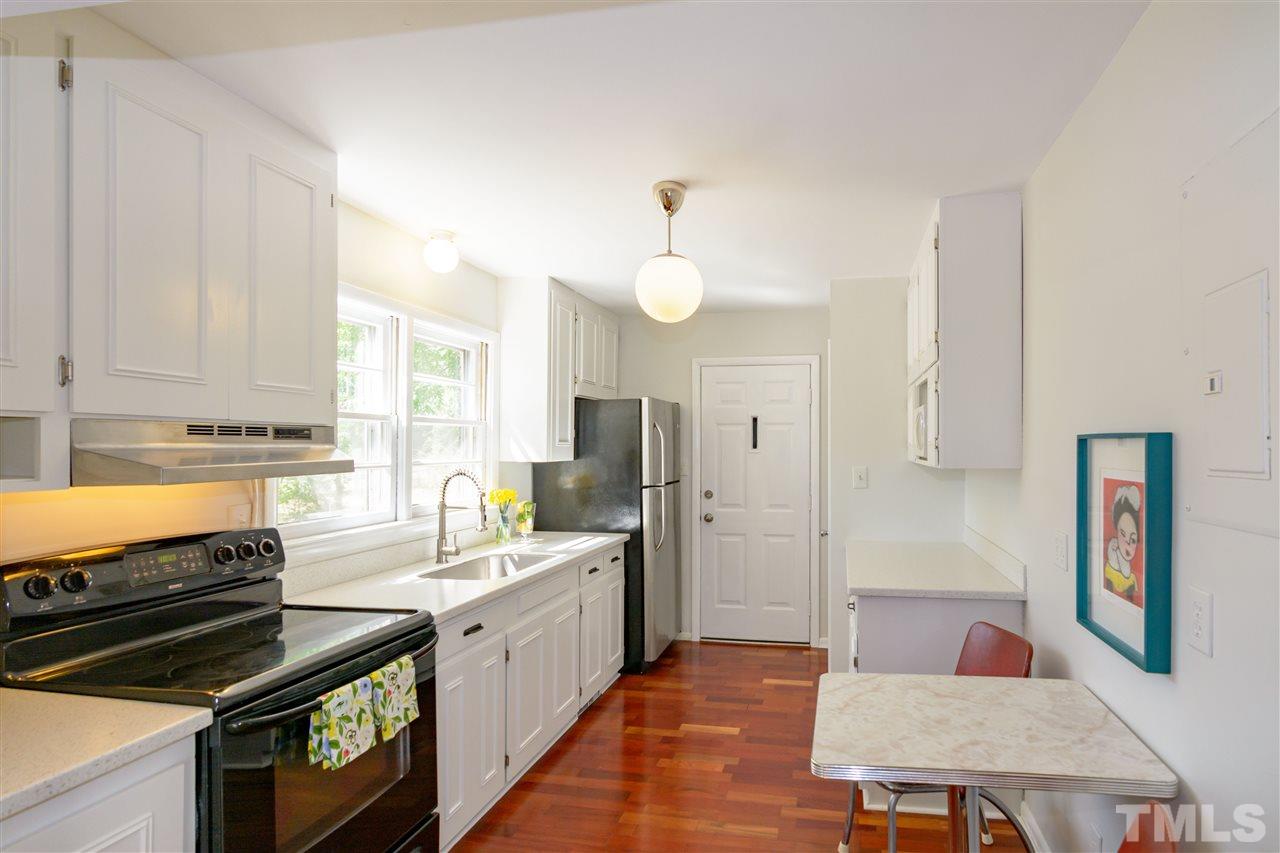 1800 Charles Raleigh, NC 27610 - Photo 13 of 28 a large kitchen with a stove a sink dishwasher and a refrigerator with wooden floor