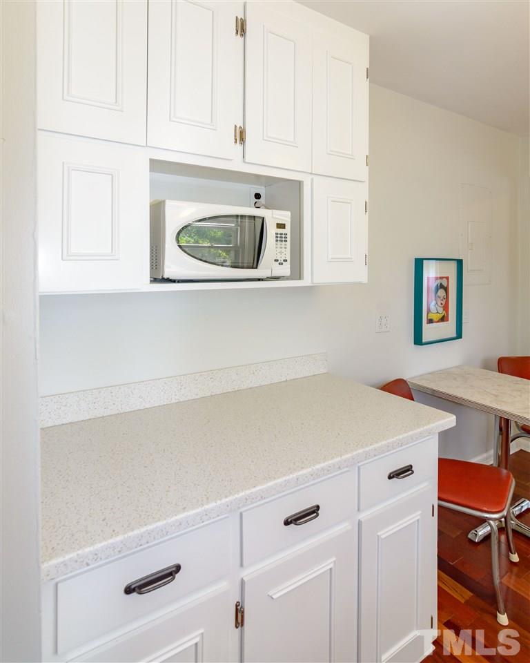 1800 Charles Raleigh, NC 27610 - Photo 15 of 28 a kitchen with white cabinets and white appliances