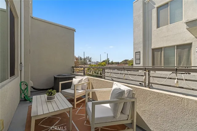 a balcony with table and chairs