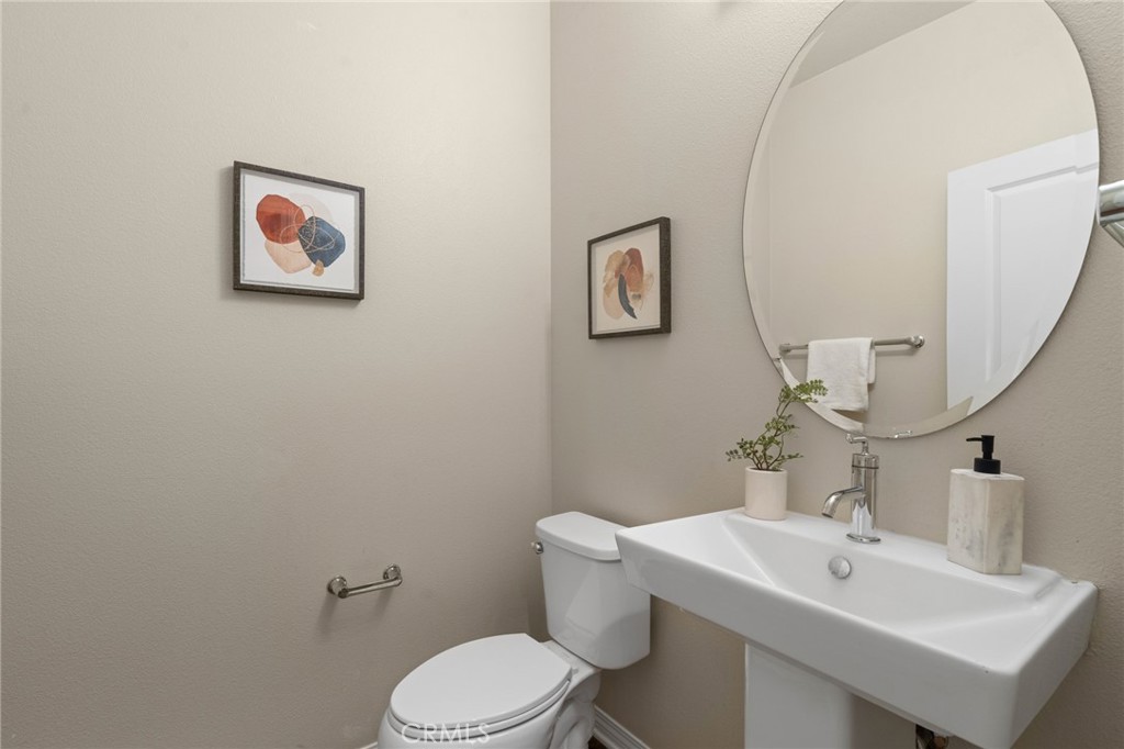 12913 Mission Hawthorne Ca, Unit 108 Hawthorne, CA 90250 - Photo 12 of 31 a bathroom with a sink mirror and toilet