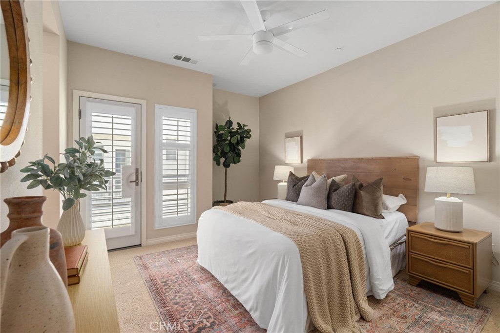 12913 Mission Hawthorne Ca, Unit 108 Hawthorne, CA 90250 - Photo 15 of 31 a bedroom with a large bed and a potted plant