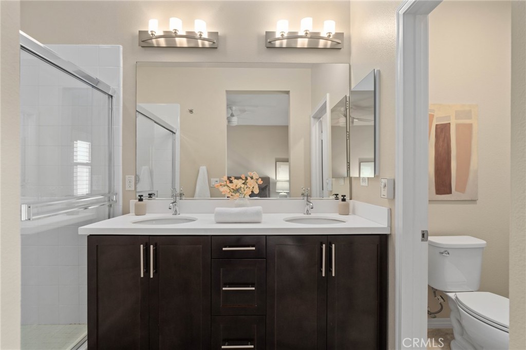 12913 Mission Hawthorne Ca, Unit 108 Hawthorne, CA 90250 - Photo 16 of 31 a bathroom with a double vanity sink toilet and a mirror
