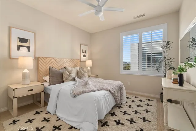 a bedroom with a bed and a window with wooden floor