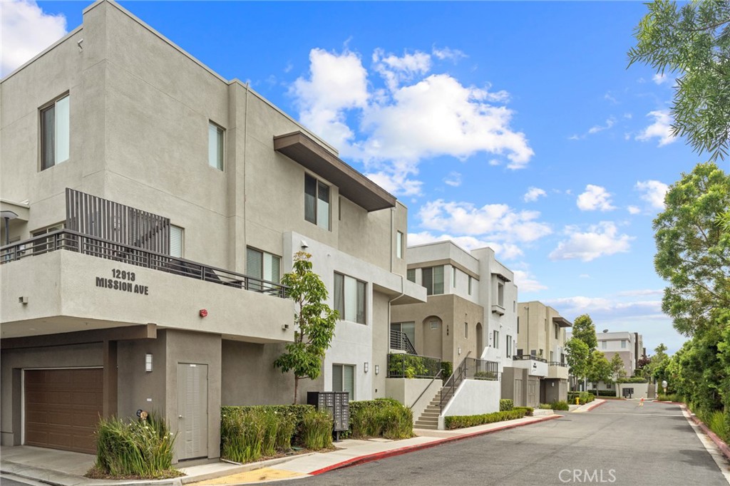 12913 Mission Hawthorne Ca, Unit 108 Hawthorne, CA 90250 - Photo 2 of 31 a view of a white building among the street with palm trees