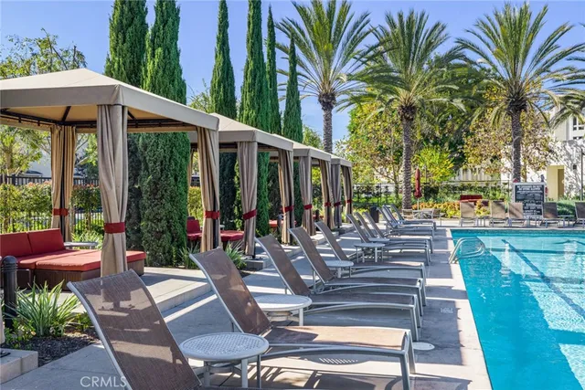 a view of a patio with table and chairs potted plants and palm tree