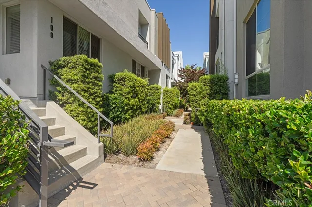 a view of a pathway both side of house