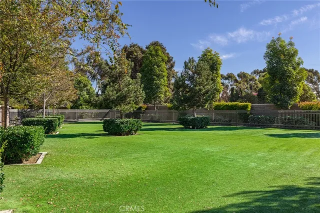 a view of a garden with a building in the background