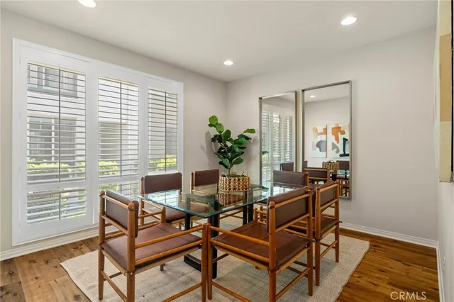 a dining room with furniture and wooden floor