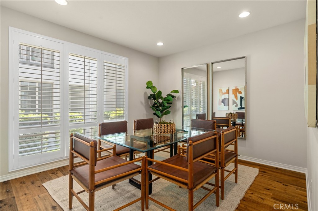 12913 Mission Hawthorne Ca, Unit 108 Hawthorne, CA 90250 - Photo 5 of 31 a dining room with furniture and wooden floor