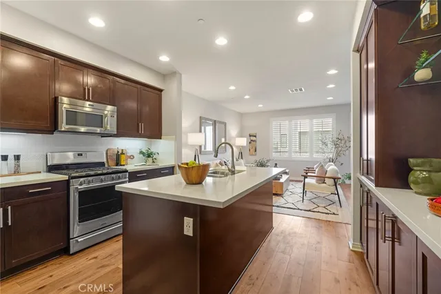 a view of kitchen with stainless steel appliances granite countertop sink stove and microwave