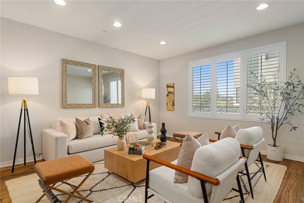 12913 Mission Hawthorne Ca, Unit 108 Hawthorne, CA 90250 - Photo 9 of 31 a living room with furniture and a large window