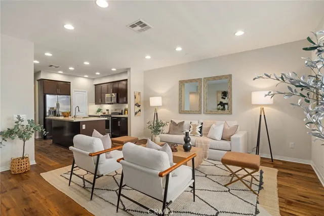 a living room with fireplace furniture and a wooden floor