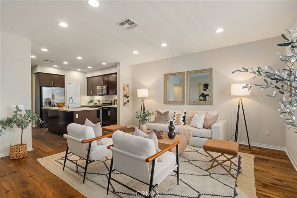 12913 Mission Hawthorne Ca, Unit 108 Hawthorne, CA 90250 - Photo 10 of 31 a living room with fireplace furniture and a wooden floor