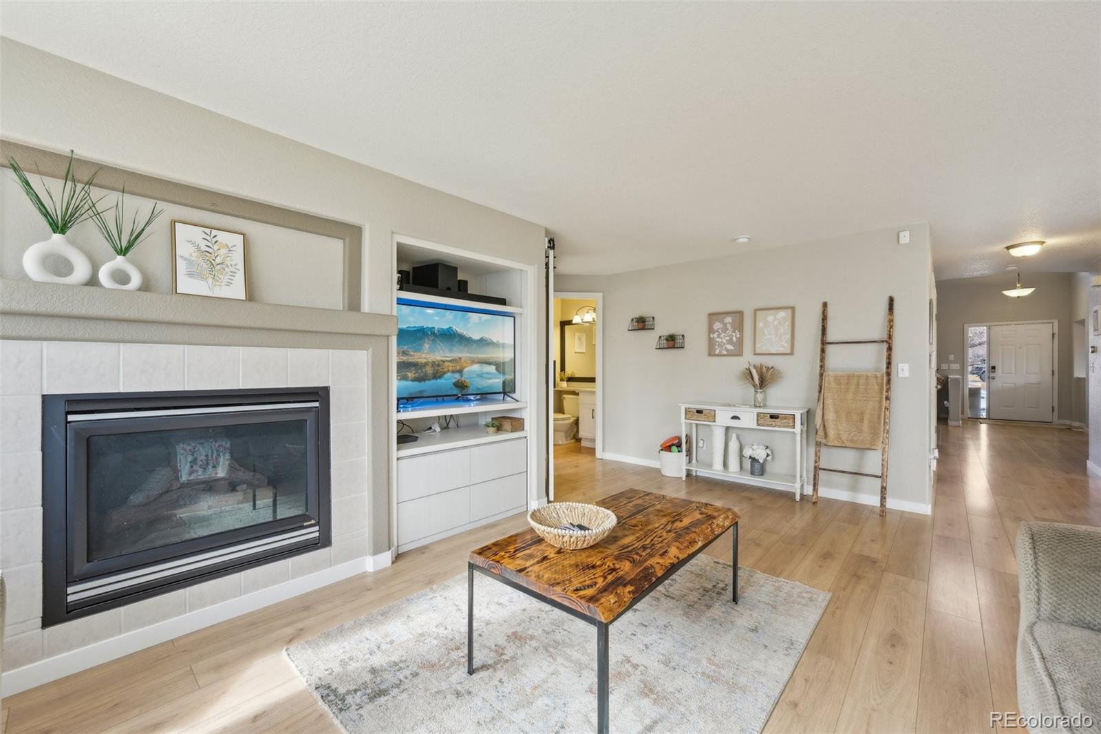 591 Rio Rancho Way Brighton, CO 80601 - Photo 11 of 47 a living room with furniture and a fireplace
