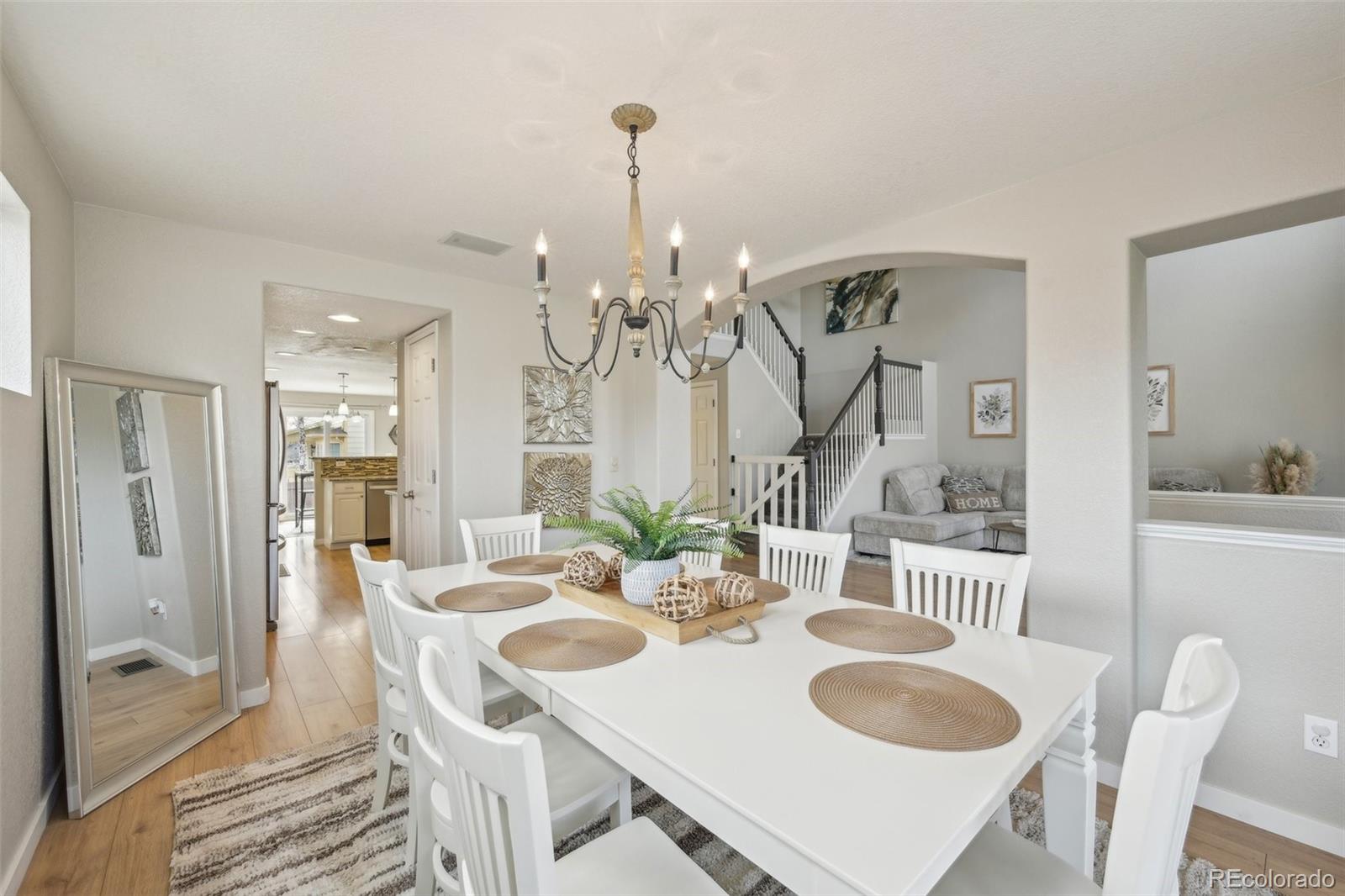 591 Rio Rancho Way Brighton, CO 80601 - Photo 14 of 47 a view of a dining room with furniture and wooden floor