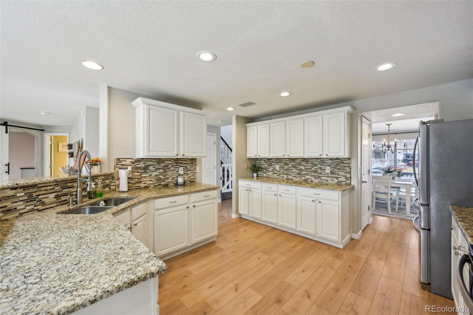 591 Rio Rancho Way Brighton, CO 80601 - Photo 15 of 47 a kitchen with a sink stove and refrigerator