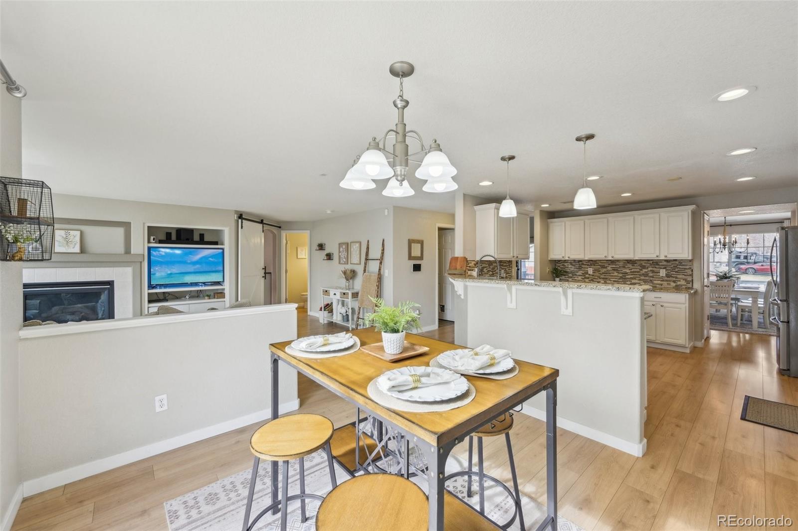 591 Rio Rancho Way Brighton, CO 80601 - Photo 17 of 47 a view of a dining room with furniture and wooden floor