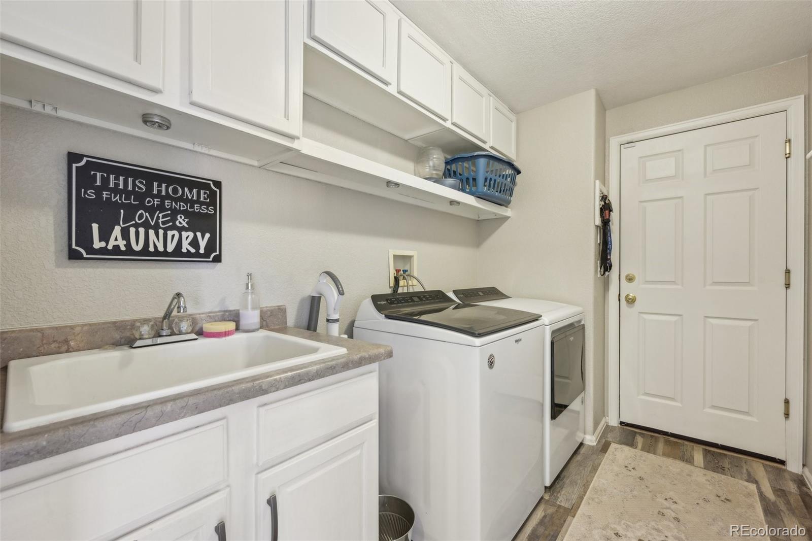 591 Rio Rancho Way Brighton, CO 80601 - Photo 22 of 47 a utility room with sink dryer and washer