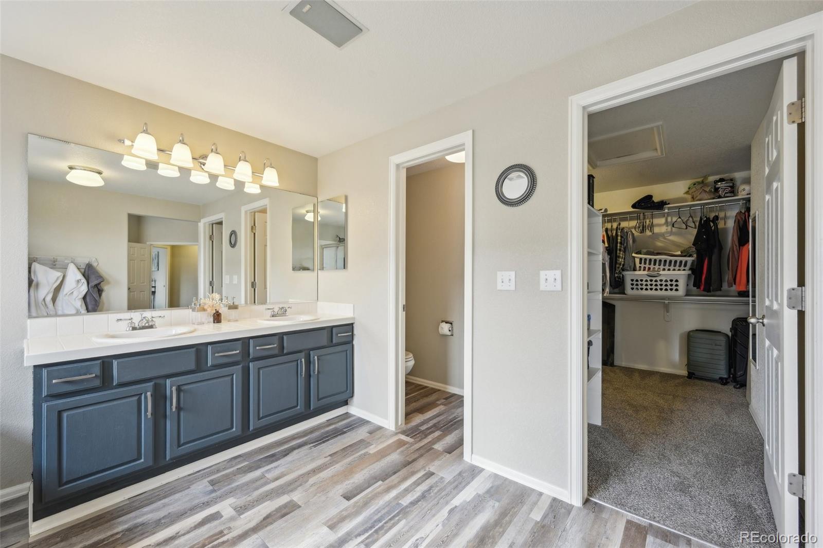 591 Rio Rancho Way Brighton, CO 80601 - Photo 27 of 47 a spacious bathroom with a double vanity sink and a mirror