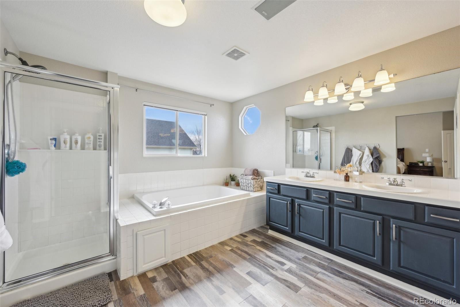 591 Rio Rancho Way Brighton, CO 80601 - Photo 28 of 47 a spacious bathroom with a double vanity sink mirror and bathtub