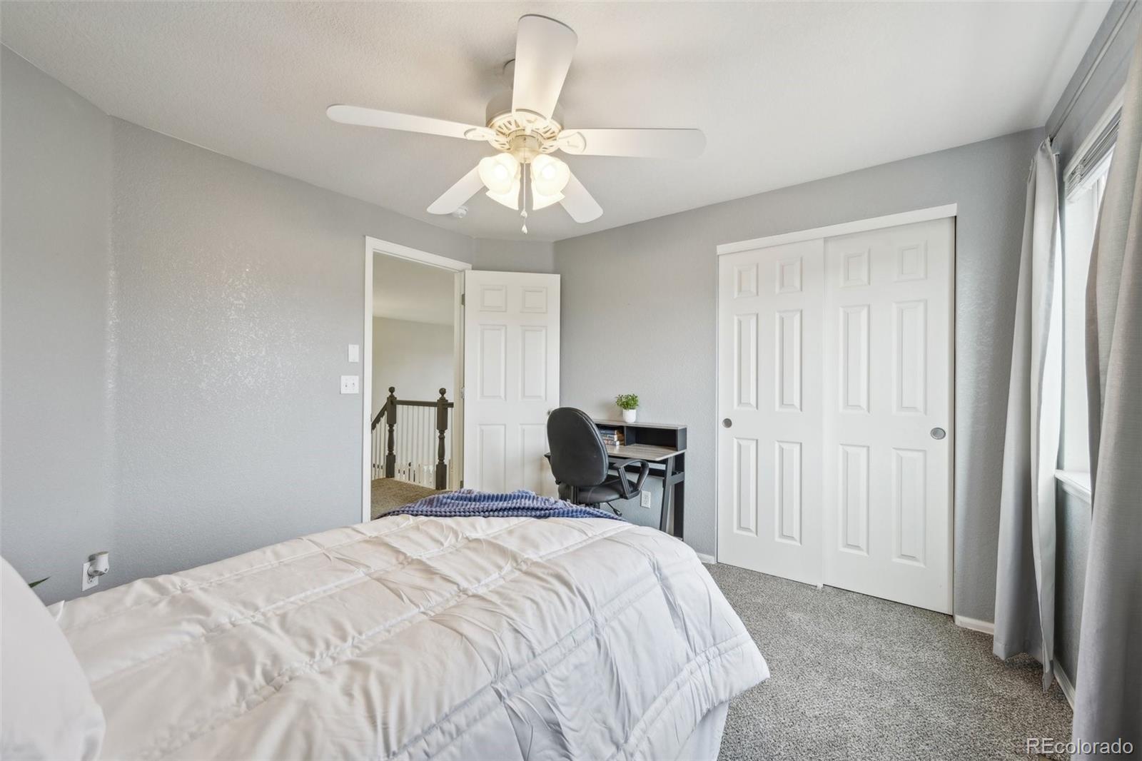 591 Rio Rancho Way Brighton, CO 80601 - Photo 32 of 47 a bedroom with a bed and a chandelier