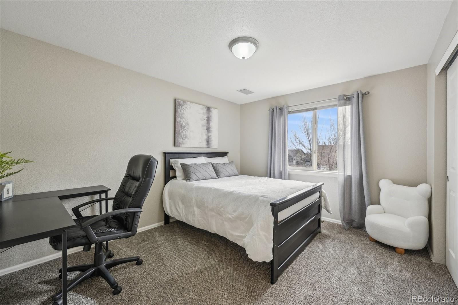 591 Rio Rancho Way Brighton, CO 80601 - Photo 34 of 47 a bedroom with a bed chair and a window