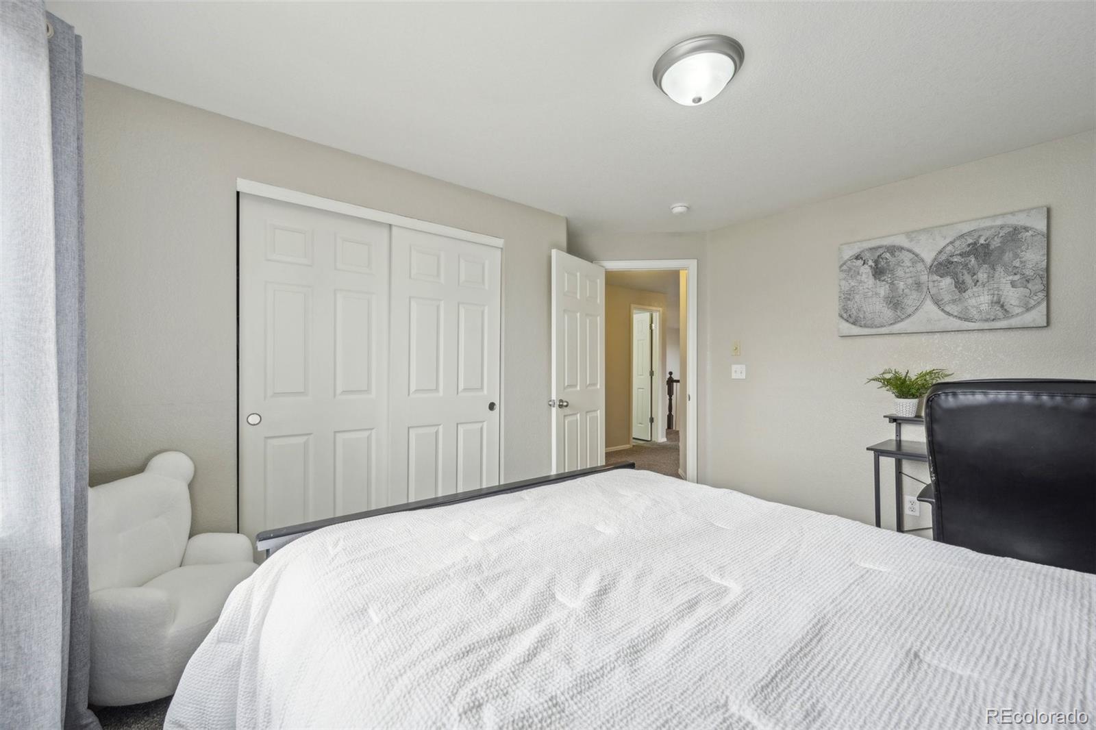 591 Rio Rancho Way Brighton, CO 80601 - Photo 35 of 47 a bedroom with a bed and a painting on the wall