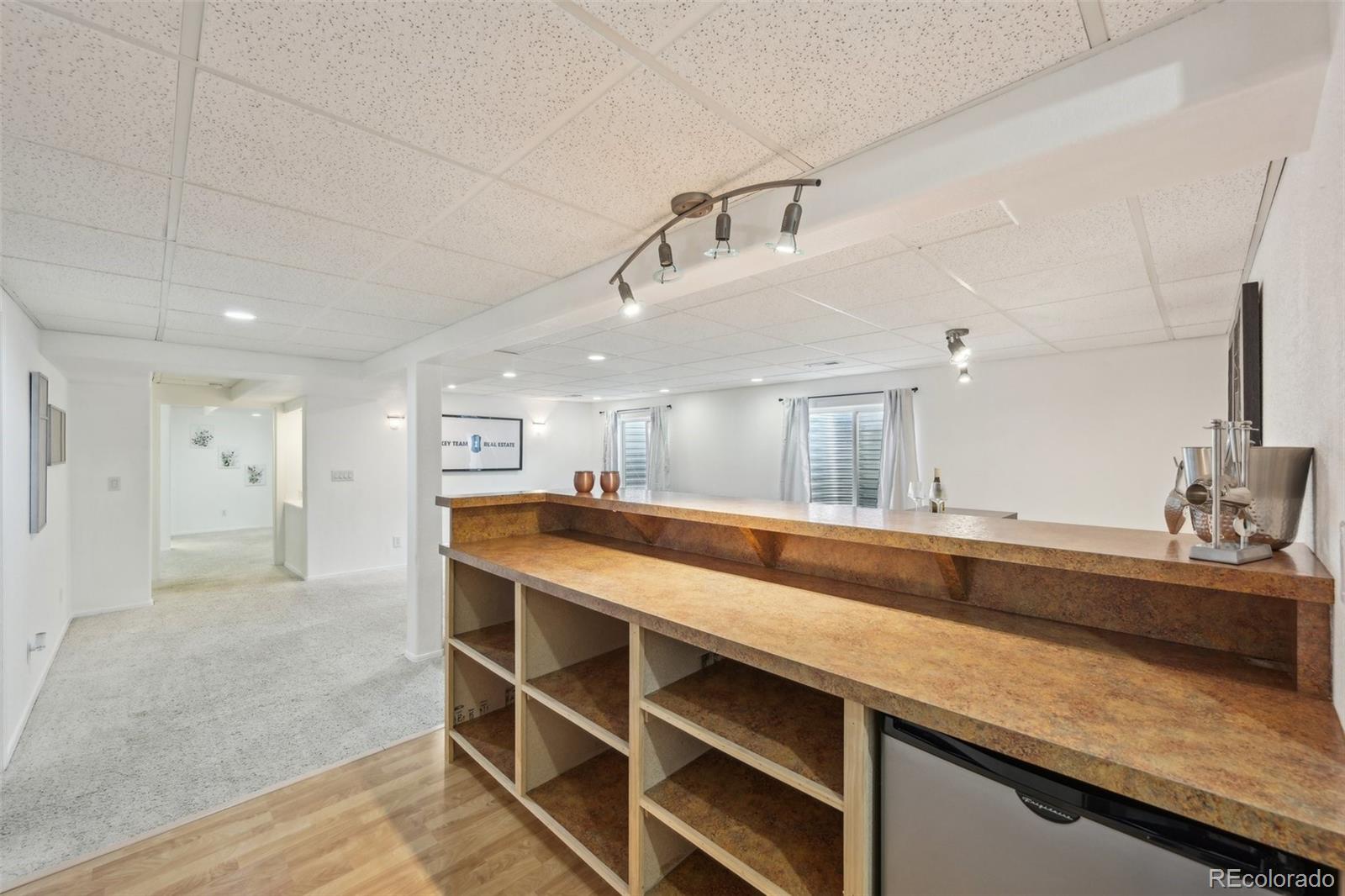 591 Rio Rancho Way Brighton, CO 80601 - Photo 39 of 47 a kitchen with kitchen island a sink and wooden floor