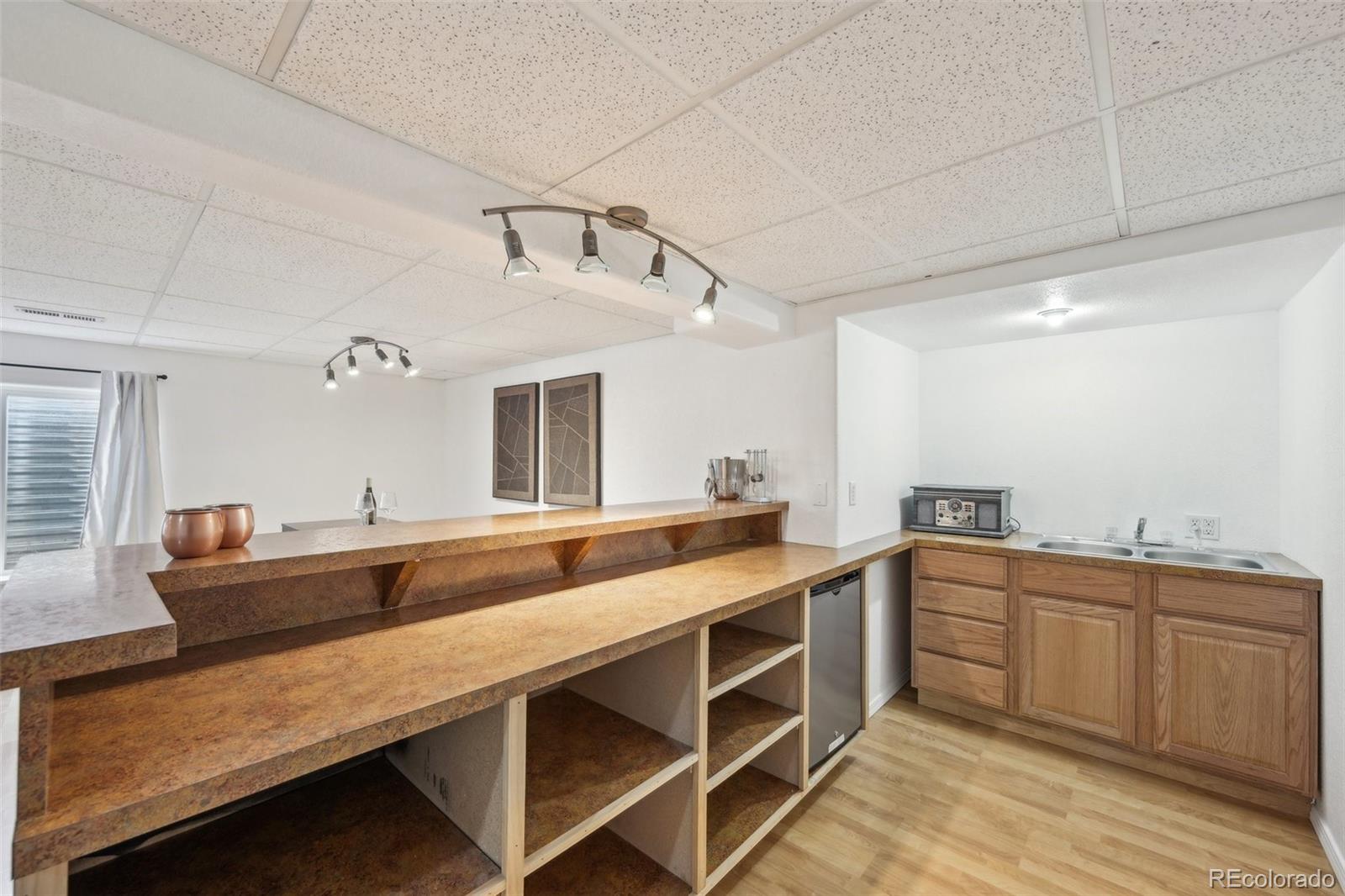 591 Rio Rancho Way Brighton, CO 80601 - Photo 40 of 47 a view of a kitchen with kitchen island a sink and wooden floors