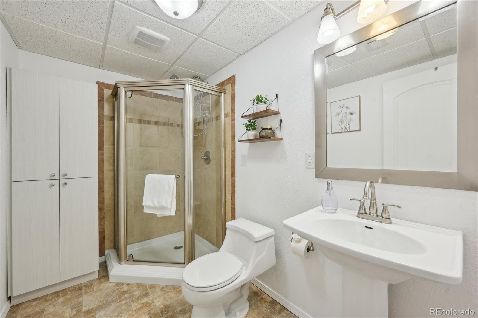 591 Rio Rancho Way Brighton, CO 80601 - Photo 44 of 47 a bathroom with a sink toilet and shower