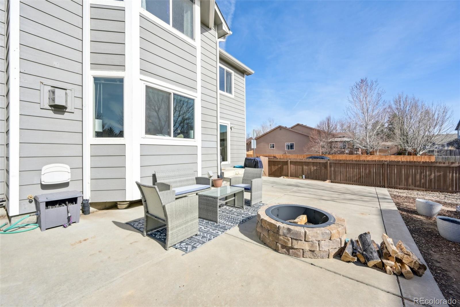 591 Rio Rancho Way Brighton, CO 80601 - Photo 47 of 47 a view of a terrace with furniture and a garden