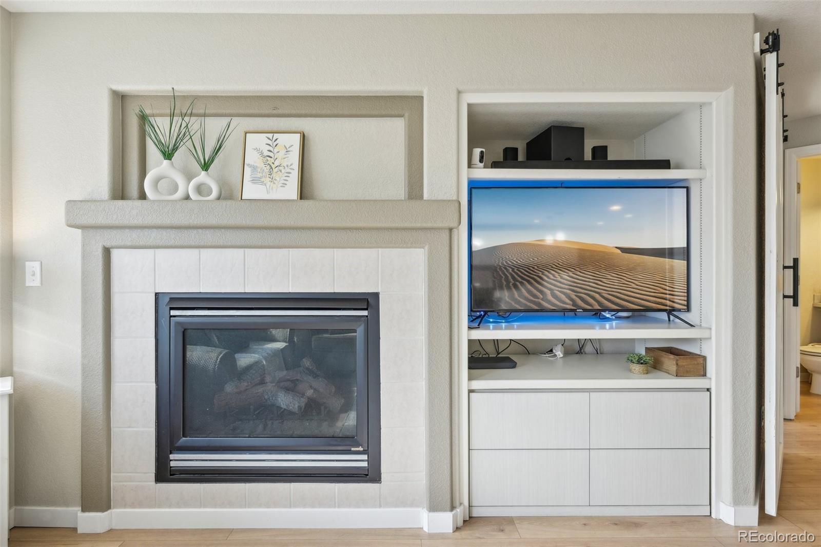 591 Rio Rancho Way Brighton, CO 80601 - Photo 8 of 47 a living room with a fireplace and wooden floor