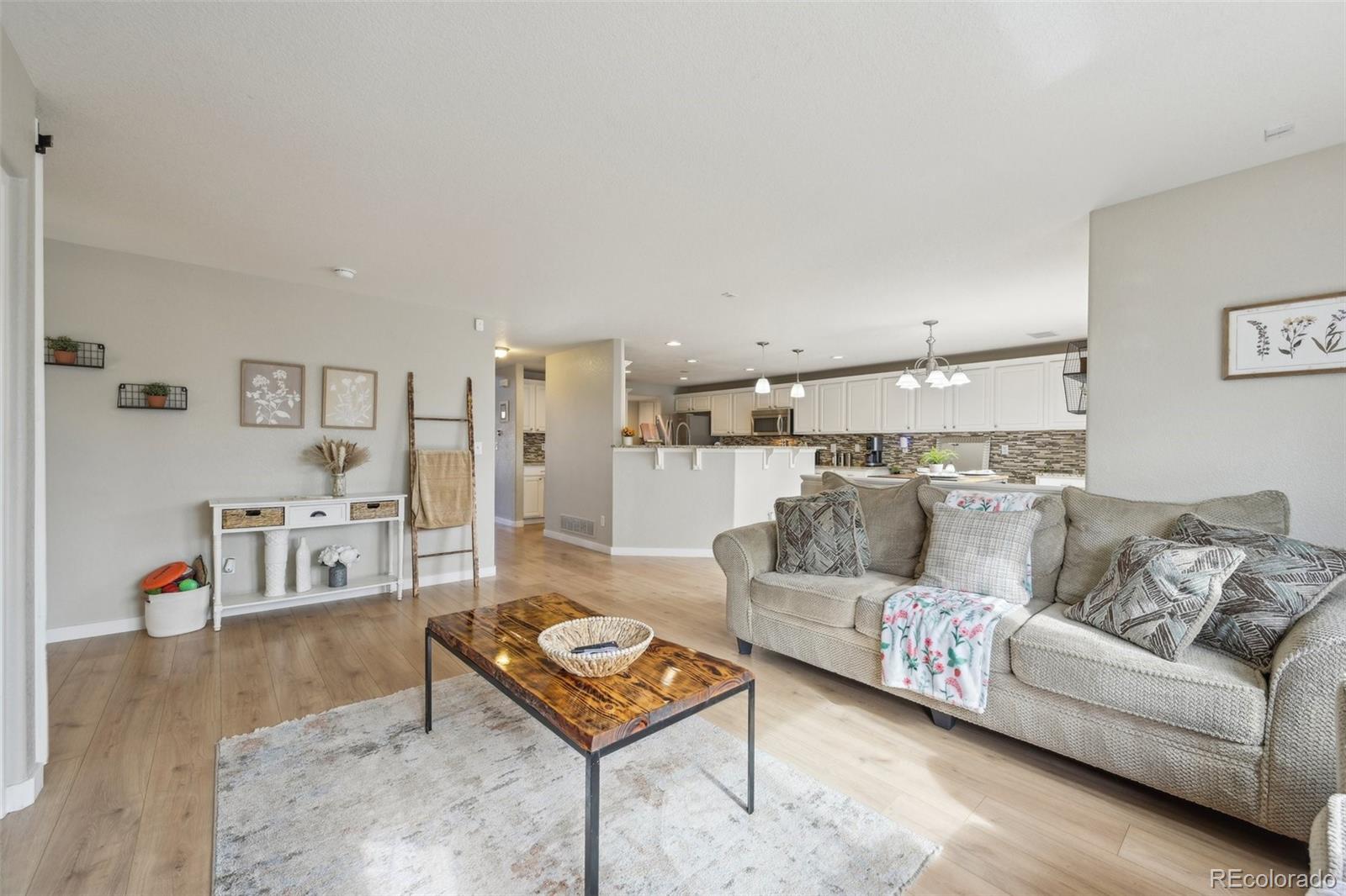 591 Rio Rancho Way Brighton, CO 80601 - Photo 10 of 47 a living room with furniture and a table