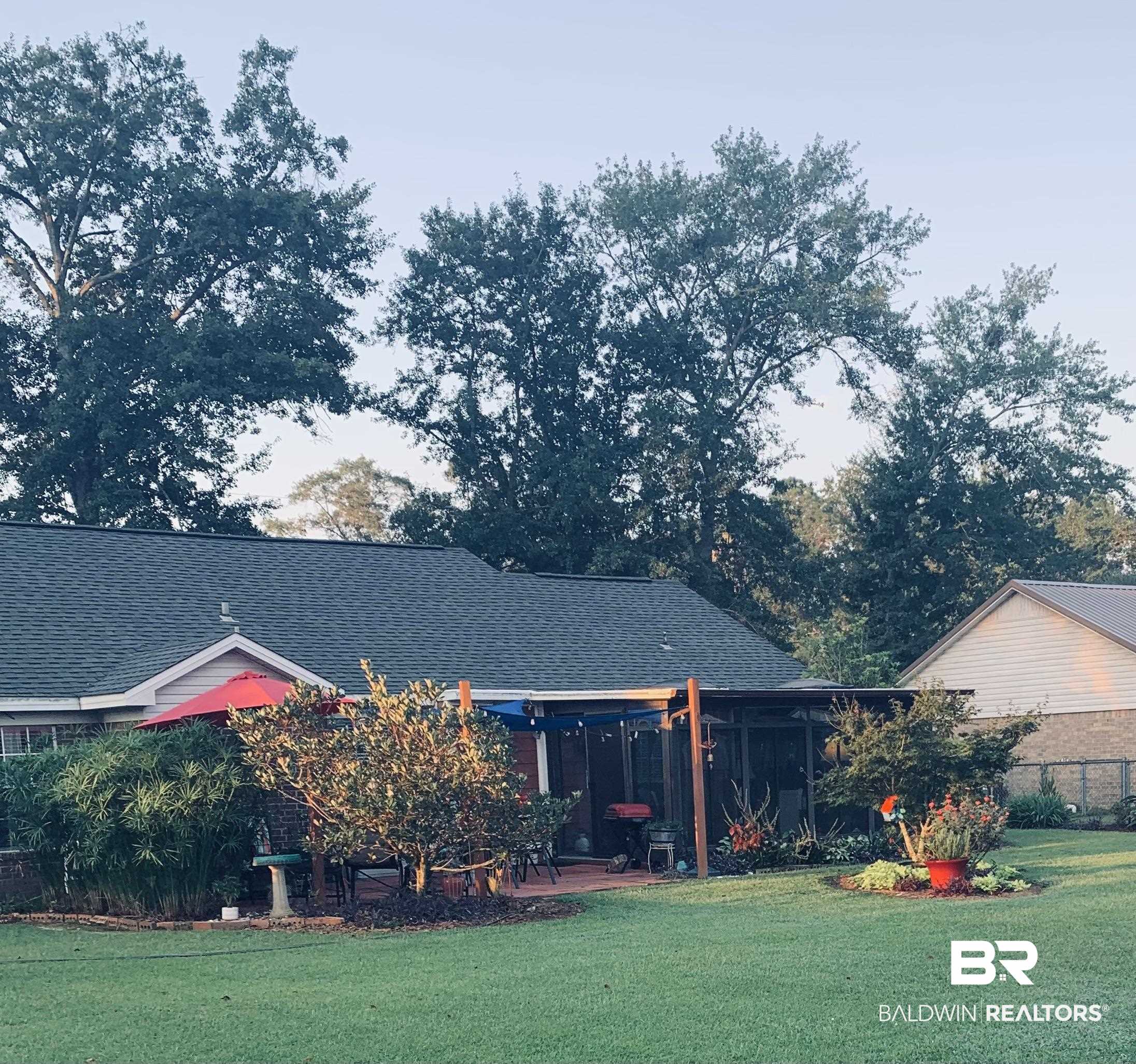 519 Juniper Place Drive Foley, AL 36535 - Photo 40 of 47 Rear view of house with a shingled roof, a yard, and a patio