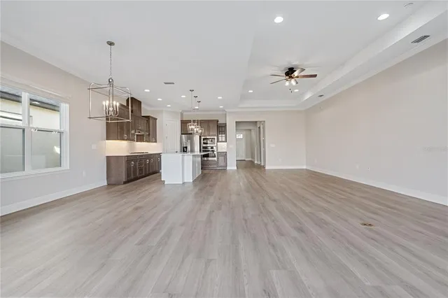 a view of a kitchen with a sink dishwasher a kitchen counter space and wooden floor