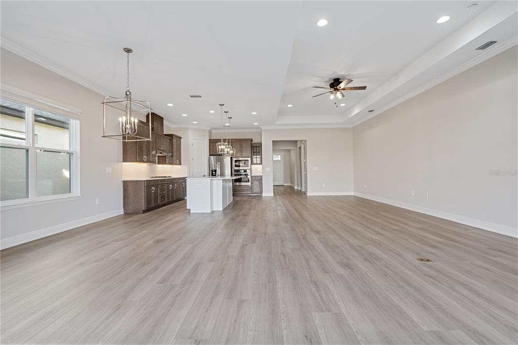7851 Stoney Bay Loop Kissimmee, FL 34747 - Photo 12 of 33 a view of a kitchen with a sink dishwasher a kitchen counter space and wooden floor