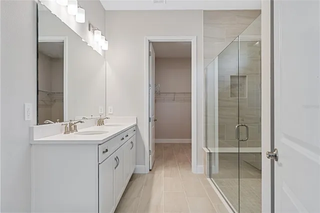 a bathroom with a double vanity sink and mirror