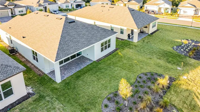 a aerial view of a house with a yard and a garage